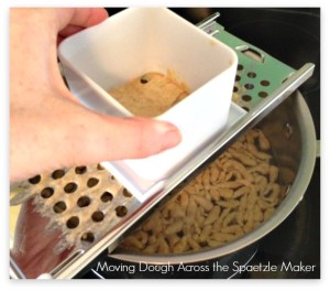 Moving dough through spaetzle maker
